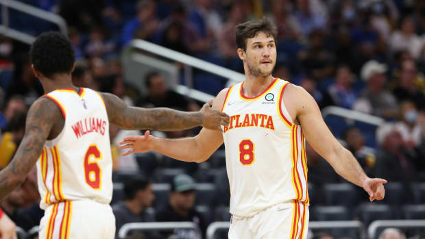 Dec 15, 2021; Orlando, Florida, USA; Atlanta Hawks forward Danilo Gallinari (8) celebrates with Atlanta Hawks guard Lou Williams (6) as he makes a three point basket against the Orlando Magic during the second half at Amway Center.